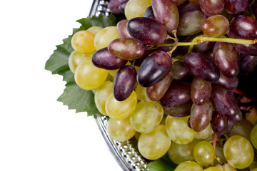 Red and green grapes on a metal tray