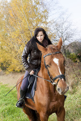 Fototapeta premium equestrian on horseback in autumnal nature