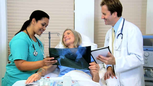 Radiologist Discussing X-Ray Film with Patient