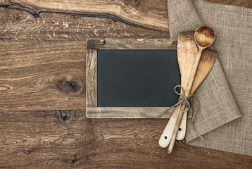 Retro kitchen utensils and vintage blackboard