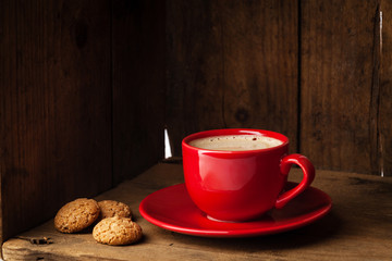 Coffee cup and amaretti biscuits on wooden background