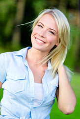 Pretty girl with her arms outstretched having fun at park