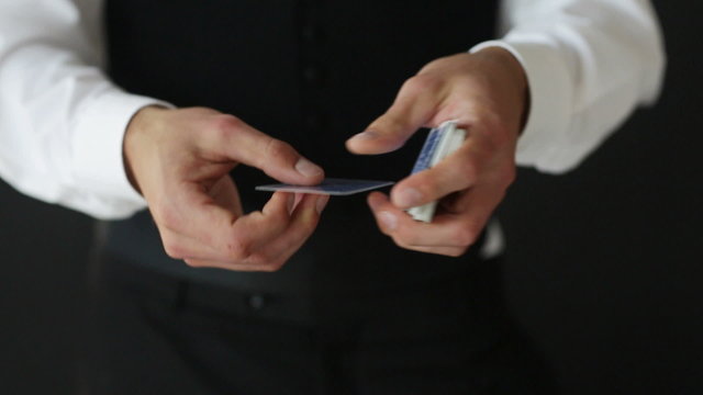 man showing trick with playing cards
