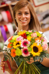 Female Florist is creating a colorful bouquet