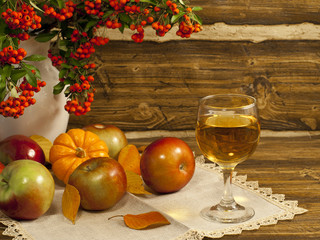 Autumn composition with white wine, apples and pumpkin.