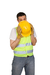 Shy construction worker isolated on white background.