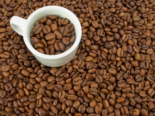 coffee beans and a white espresso cup