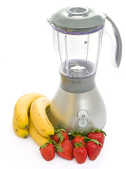 Blender with strawberries and bananas isolated