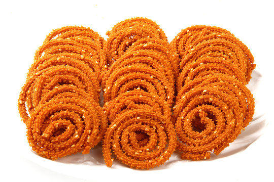 Traditional indian snack - chakali, isolated on white.