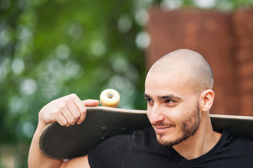 Man portrait holding skateboard.