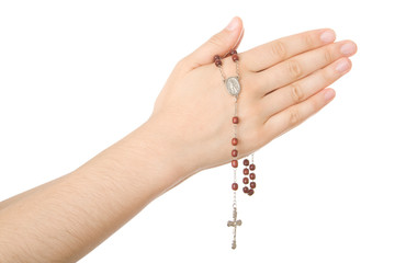 Hands closed in prayer with a rosary isolated