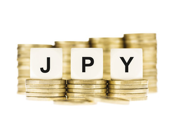 JPY (Japanese Currency) over  Gold Coin Stack Isolated on White