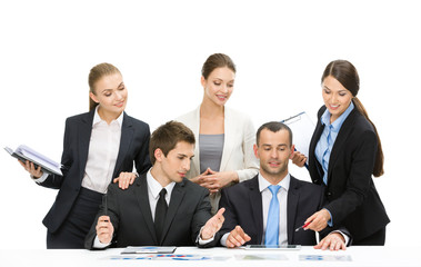 Group of executives working while sitting at the table