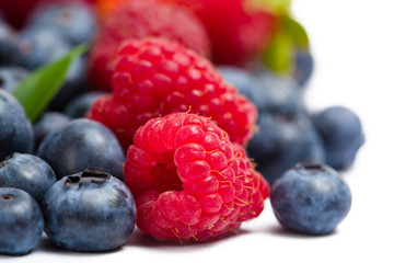 Close up of heap of strawberry, bilberry and raspberry, isolated