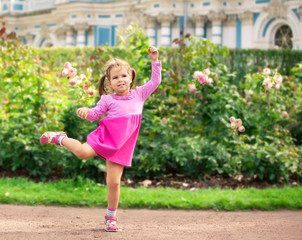 little girl dancing in the park like ballerina