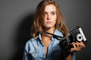 Sexy photographer woman with old camera