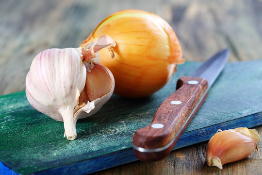 Onions, garlic and a knife.