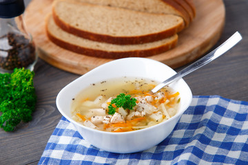 Bowl of chicken soup with vegetables and noodles