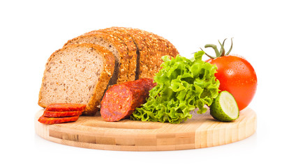 bread and smoked sausages on wooden plate isolated on white