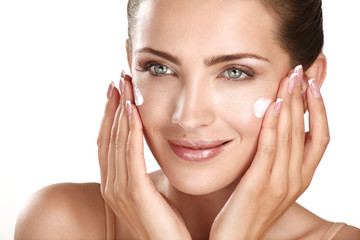 beautiful model applying cosmetic cream treatmen on her face - 56563514