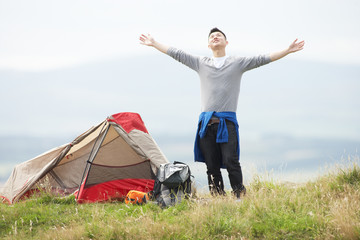 Young Man On Camping Trip In Countryside