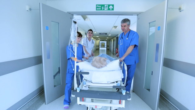 Nursing Staff Pushing Patient Bed Hospital