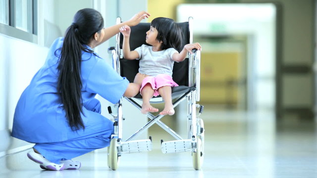 Ethnic Female Child Comforted Asian Indian Nurse Before Treatment