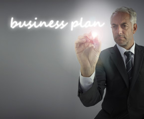 Serious businessman writing business plan