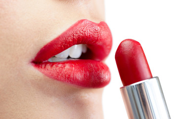 Naklejka premium Extreme close up on model applying red lipstick