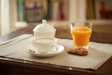 Breakfast table with juice, coffe and cookies
