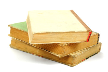 Stack of old books on a white background.