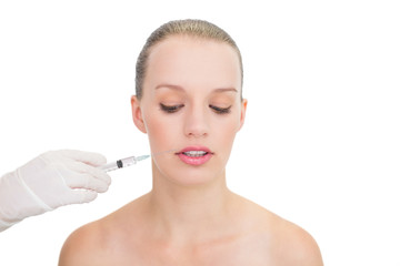 Stressed pretty blonde model receiving botox injection