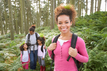 Family Group Hiking In Woods Together