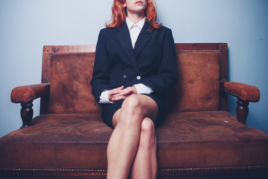 Confident young businesswoman sitting on sofa