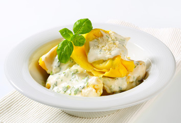 Ricotta and spinach tortelloni with cream sauce and Parmesan