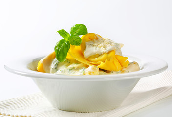 Ricotta and spinach tortelloni with cream sauce and Parmesan