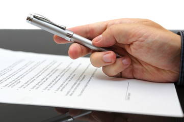 Businessman offering  a pen to sign a contract