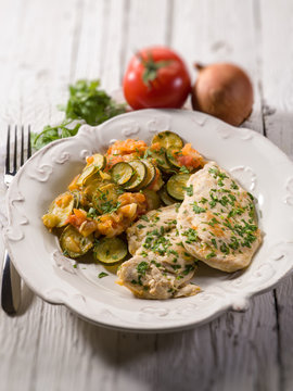 escalope with tomatoes and zucchinis, selective focus