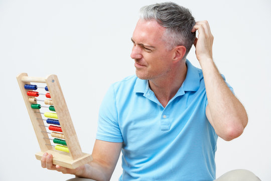 Puzzled Man Using Abacus