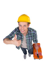 Handyman. Top view of cheerful craftsperson looking at camera an