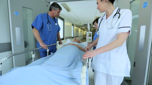 Slow Motion Nursing Staff Pushing Patient Bed Hospital