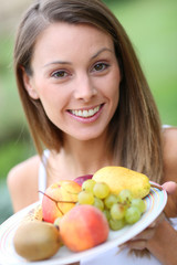 Portrait of beautiful girl holding fresh fruits