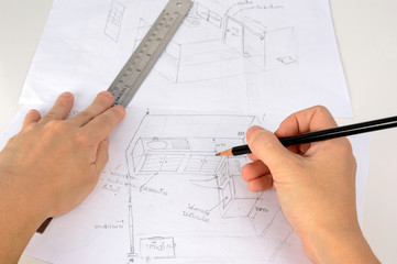 Hand is drawning  sketch of the kitchen with pencil and ruler