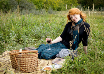 Portrait of a beautiful redhair girl in the autumn park.