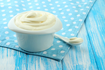 Sour cream in bowl on table close-up
