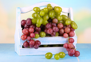 Ripe green and purple grapes in basket