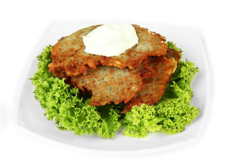 Potato pancakes on plate, isolated on white