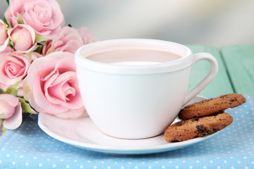 Cocoa drink  and cookies on wooden  table, on bright background