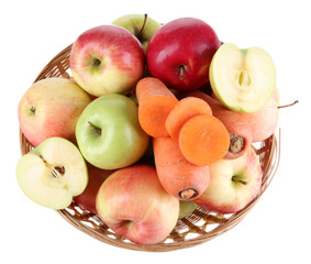 Sweet apples and carrots in basket isolated on white