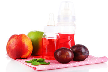 Fruits and baby bottles with compote on napkin isolated on